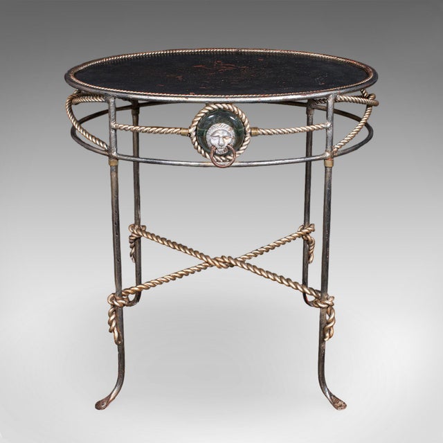 This is a vintage oval garden table. A French, cast iron and steel veranda serving table in Regency revival taste, dating...