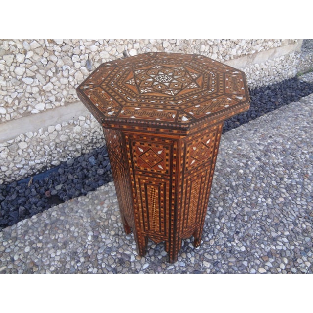 Vintage Middle Eastern Arabesque style Inlaid octagonal table. This handsome middle eastern or Islamic Arabesque style...