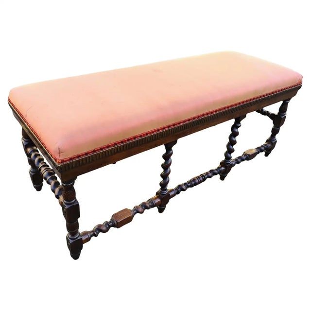 This finely crafted French bench features rich oak with deeply carved barley twist legs and stretchers that showcase...
