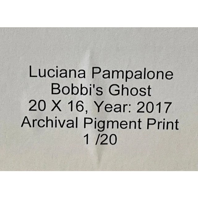A modern genre photography archival pigment print titled " Bobbi's ghost" featuring a lady with three open umbrellas near...