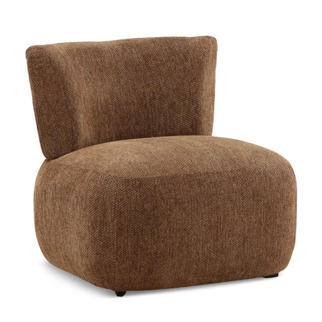 Sculptural soft lounge chair featuring a gently curved back and low, grounded profile. Upholstered in a richly textured...