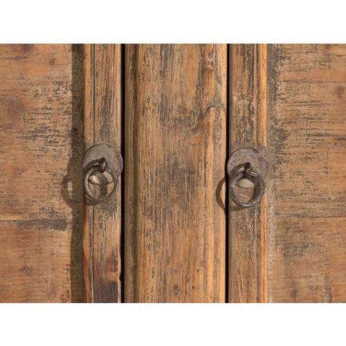 This antique three-door sideboard in pine wood is a plain-panelled Chinese cabinet with rounded corners and ring pulls. It...