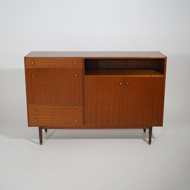 An Italian sideboard from the 1960s characterised by an articulated and functional composition, combining closed storage,...