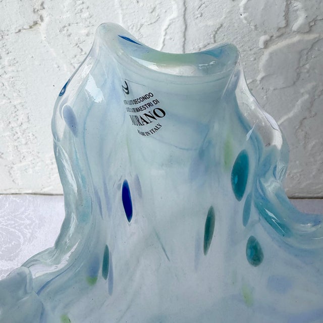 An elegant Italian hand-blown art glass vase crafted in the Murano tradition, featuring a graceful freeform silhouette...