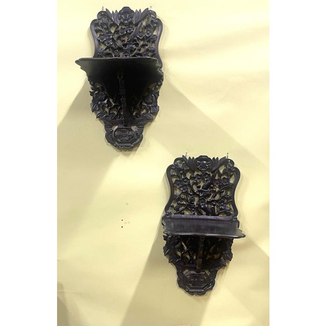 Exceptional best describes this beautiful pair of Chinese Rosewood Carved Wall Shelves. The most prominent features are...