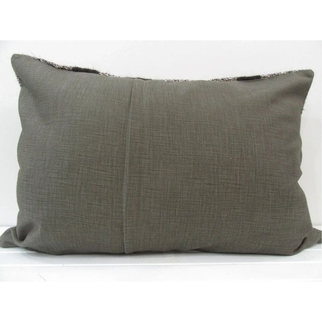 This is a pillow cover made from a vintage kilim rug. The piece was properly washed and ready to use. Pillow inserts not...