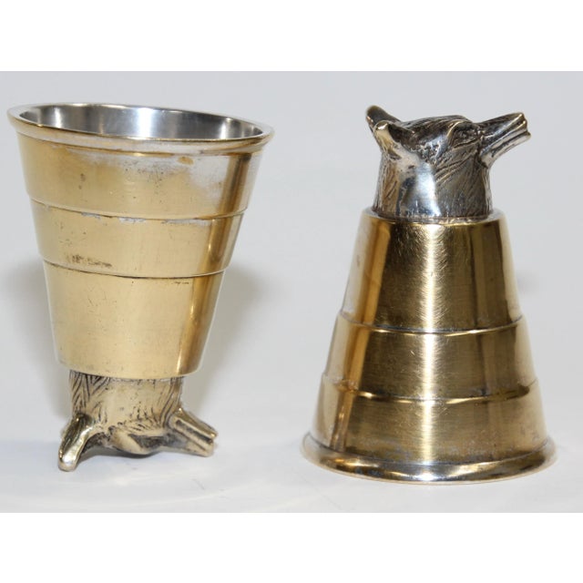 Classic Elizabeth II style stirrup cups, is of plain beaker form with a cast foxes head to one end. Set of two playful...