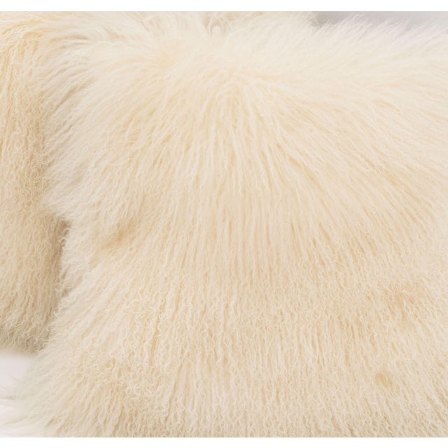 Pair of White Mongolian Lamb Pillows. 22" L x 22" W x 6" D. Provenance: From a 422 East 72nd Street Estate.