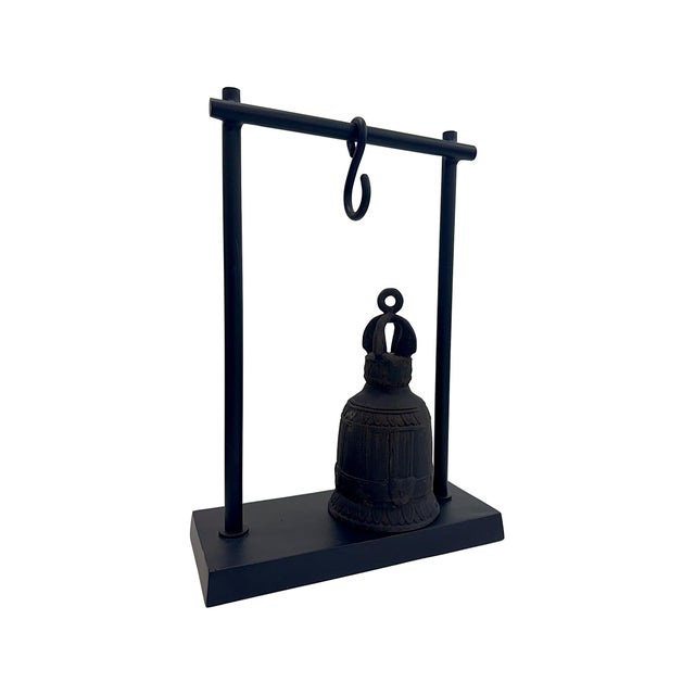 This striking hanging bell sculpture combines traditional form with a modern presentation. Crafted in matte black with...