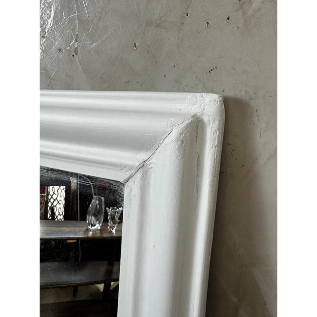 An elegant antique mirror dating from 1900, featuring a wooden frame with clean, timeless lines. We have completely...