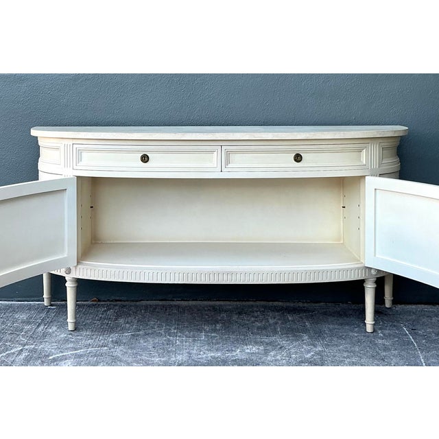 This vintage demilune sideboard is a masterful blend of Louis XVI elegance and mid-century Hollywood Regency flair. Its...