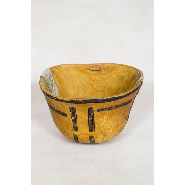 This hand-carved wooden bowl is made by the Turkana, a nomadic community in north-west Kenya prized for their woodcarving...