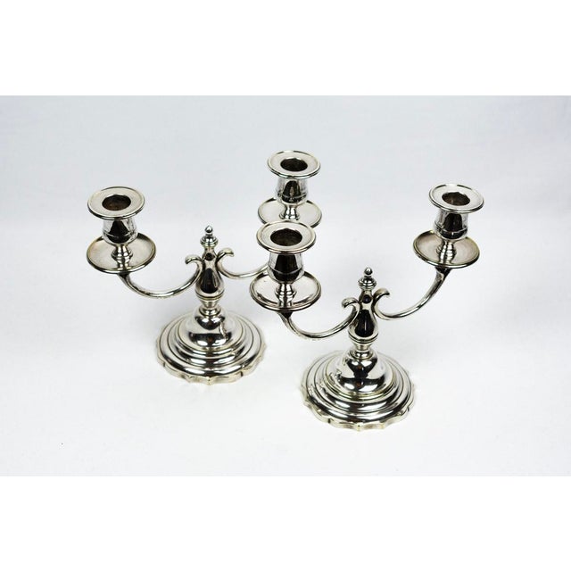 The formal vocabulary - baluster, gadrooned base, volute arm - is part of the classic repertoire of French table...