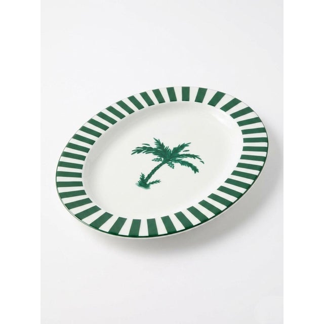 This elegant oval ceramic serving platter features a crisp, coastal aesthetic that seamlessly blends modern design with...