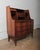 This exceptional Danish Modern secretary desk features striking bookmatched rosewood grain and sculptural drawer pulls,...
