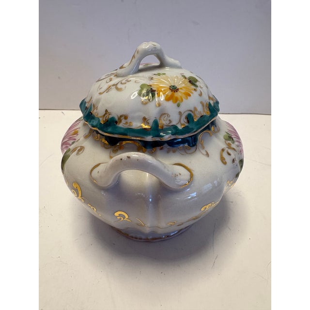 An elegant antique European porcelain covered sugar bowl dating to the late 19th–early 20th century. This finely crafted...