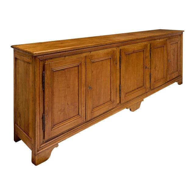 Solid wood buffet from France finished with a lustrous, hand-applied wax polish. This long piece has five doors that open...