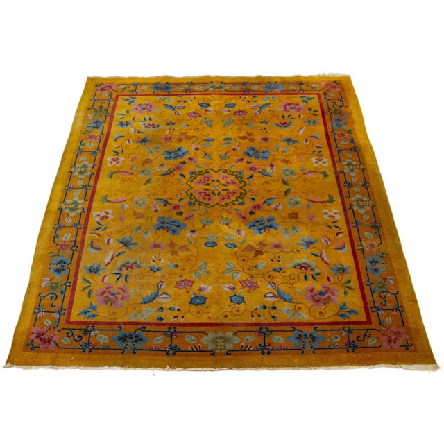 Beautiful 1920s antique Chinese Art Deco hand-knotted wool rug with goldenrod color field. This piece has a designed frame...