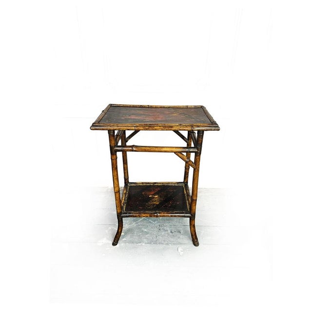 Beautiful 19th Century circa 1870 two tier bamboo table with lacquer painted table top and bottom shelf. with a wonderful...
