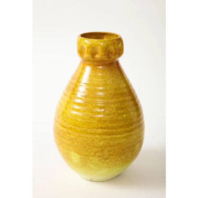 A ceramic vase in a beautiful glaze of a golden yellow produced by Accolay Pottery. Founded in the 1950s in Accolay,...