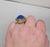 1968 goldtone prong set cabochon speckled faux-lapis "poison" adjustable ring with hidden compartment. Marked "NAPIER©" on...