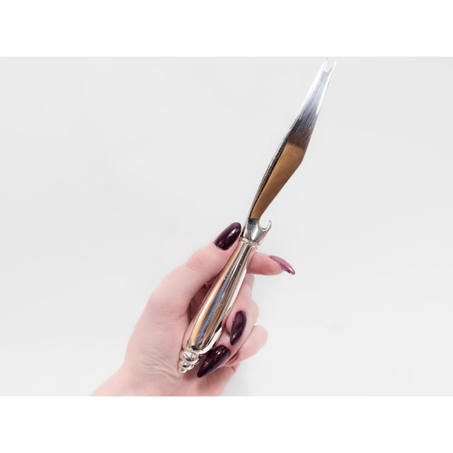 A fine signed vintage designer bar knife. By Angela Cummings for Tiffany & Co. In the 'Modern Shell' pattern. In sterling...