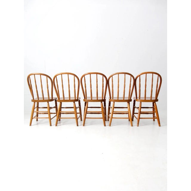 This is a beautiful set of five antique bowback Windsor style dining chairs. The classic farmhouse chairs have turned...