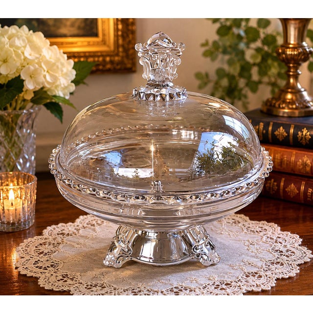 A striking antique pressed glass covered compote attributed to J.H. Hobbs, featuring exceptional figural detailing...