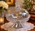 A striking antique pressed glass covered compote attributed to J.H. Hobbs, featuring exceptional figural detailing...