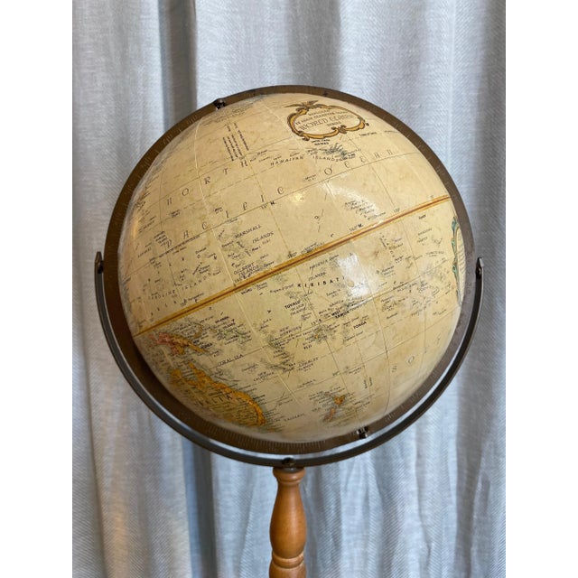 Vintage “Word Classic” model, Replogle Made in USA, tan terrestrial globe in wood and metal stand.