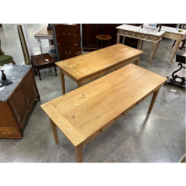 Pair of late 19th-century English stripped pine tables with drawers. Sold individually or as a pair.