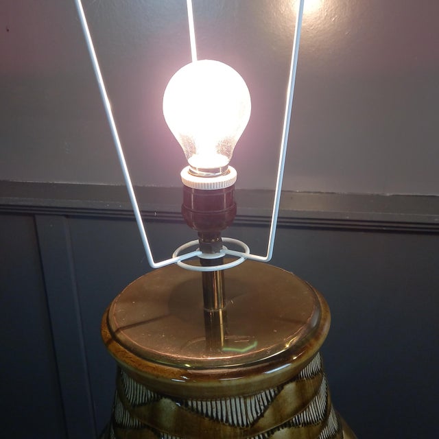 This original vintage table lamp from london, dating from the 1960s-1970s, combines a striking ceramic base with a stylish...