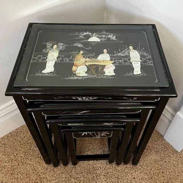 A beautiful and functional set of four (4) vintage Chinese hand-painted, black lacquer nesting tables. Each table has...