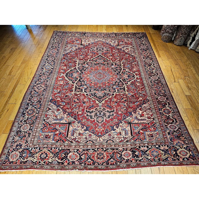 Presenting a truly astonishing piece of Persian craftsmanship, this exceptional vintage Heriz Serapi rug hails from the...