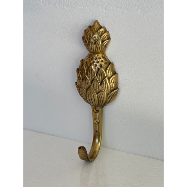 Small vintage brass pineapple hook. Most items found at Pub & Oasis are vintage and antique in nature which we believe...
