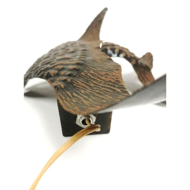 Bohemian wall arm in the shape of a sailing fish, from the 1980s. Handmade bronze wall lighting that emits a pleasant...