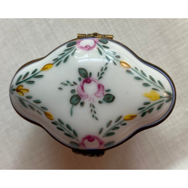 Marked Limoges, France hand painted porcelain box (unusual quatrefoil shape) with brass fittings and fastener. Marked...