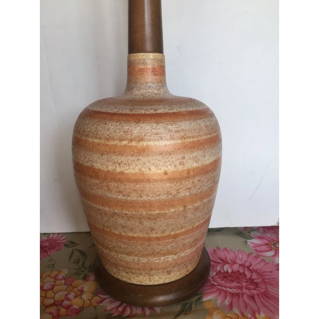 Tall Midcentury Danish Modern ceramic table lamp with volcanic glaze texture brownish stripped bands with cream body. Teak...