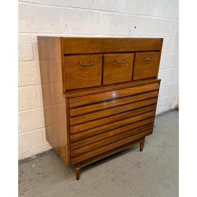 Authentic mid-century modern “Dania” highboy dresser by renowned designer Merton Gershun for American of Martinsville....