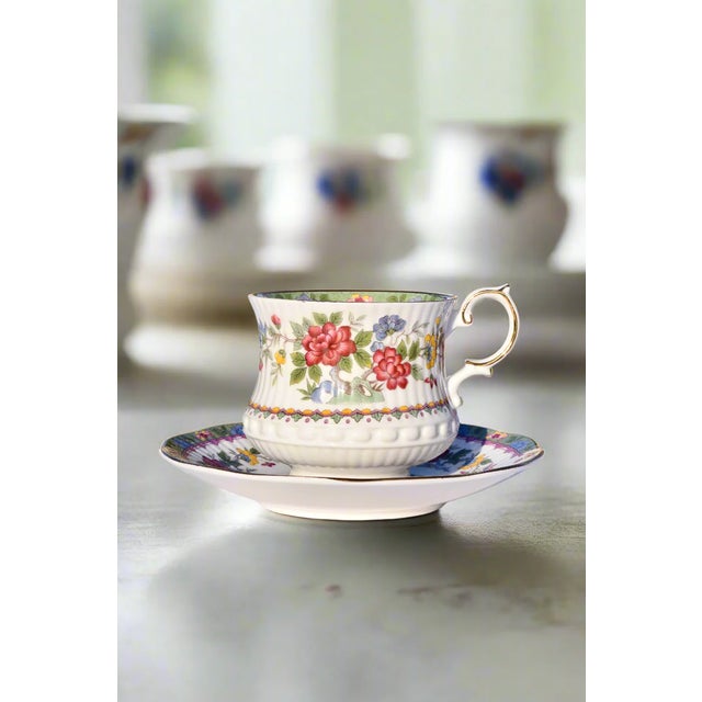 QUEEN'S ROSINA "FLOWER OF AMARAN" TEACUP & SAUCER Era: Mid-20th Century Origin: England Material: Fine Bone China with...