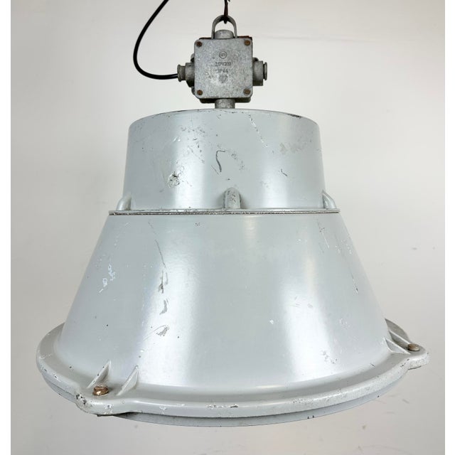 Vintage industrial hanging lamp manufactured in 1970s by mesko in skarzysko-kamienna in poland. It features a grey cast...