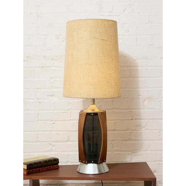A striking pair of vintage table lamps combining warm wood, smoked glass, and brushed metal for a wonderfully dramatic...