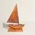 Authority runs through every inch of this 20th-century American folk art sailboat model, carved in pine with a mainsail...