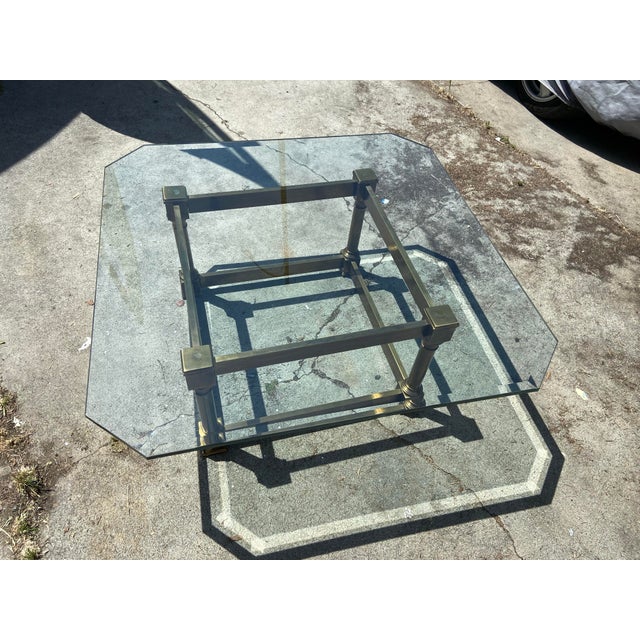 Vintage Mid Century Brass and Glass Coffee Table is a stunning piece of furniture that exudes mid-century modernism. This...