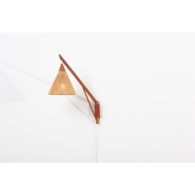 Temde Teak and Sisal wall lamp, Switzerland 1950s This lamp features three different height positions that can be adjusted...