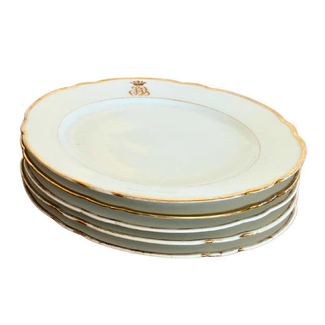 A quietly luxurious set of Limoges porcelain plates, defined by their pure white ground and refined restraint. The...