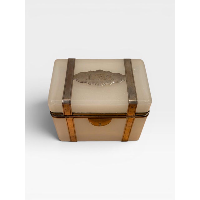 A fine and unusual French opaline glass box dating to the early 1900s, beautifully mounted in brass and sterling silver....
