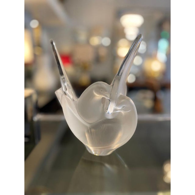 Frosted crystal vase depicting two intertwined doves with outstretched wings, designed by Marc Lalique in 1956. The...