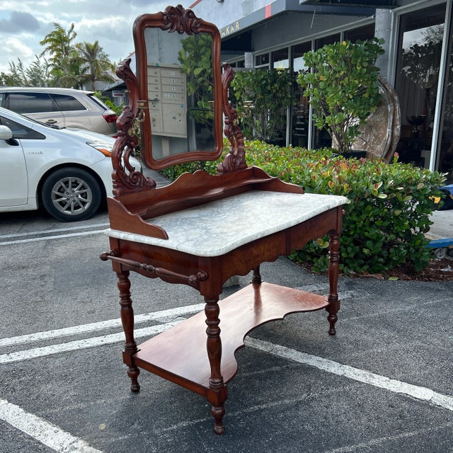 Gorgeous solid wood vanity with rounded edge marble top. Two carved drawers are part of the overall design and pull out...