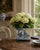 A decorative French Provincial cachepot fashioned from painted tole in a softly aged blue-and-cream palette. Each side is...